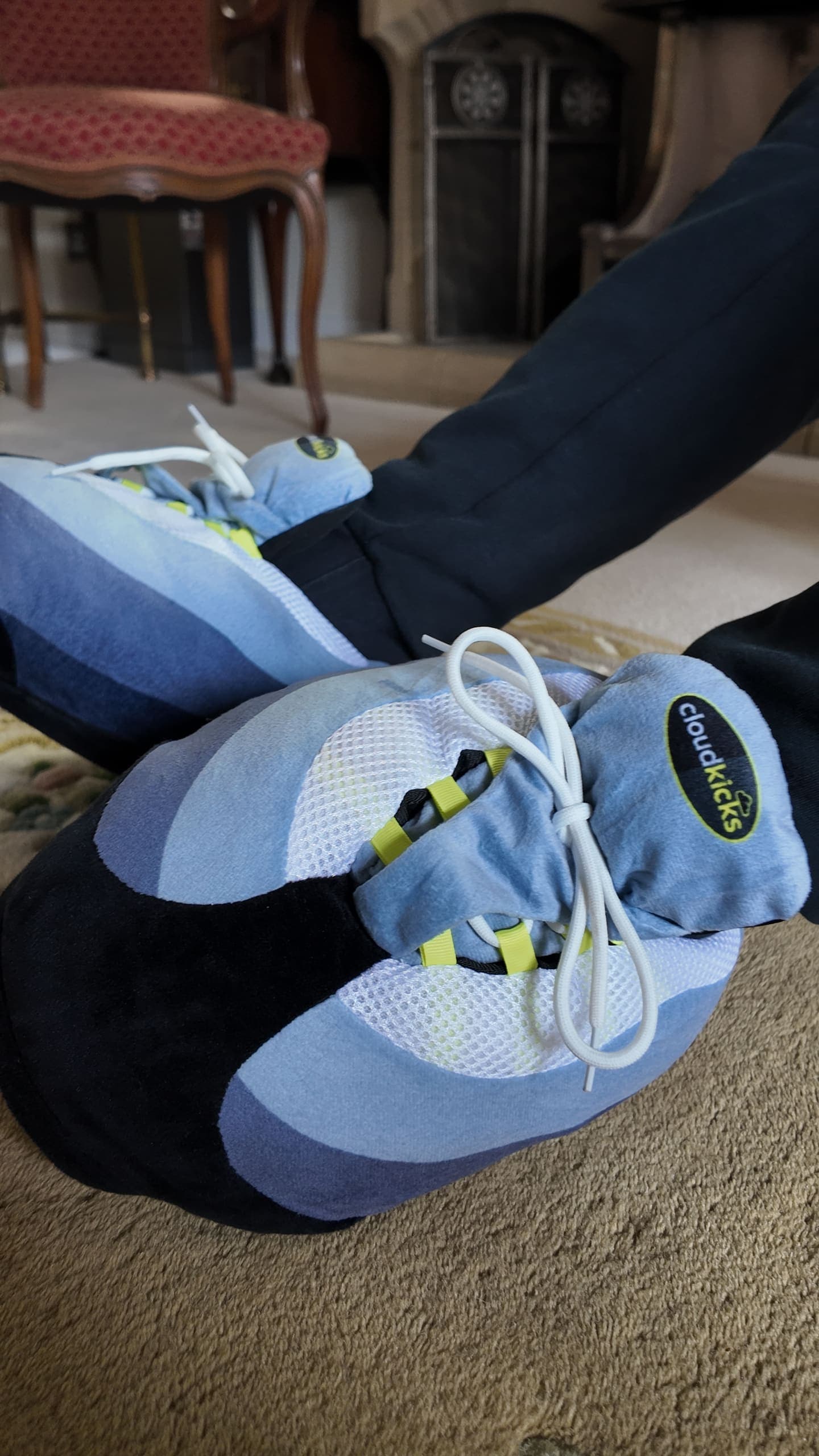 Close-up of crossed OG Neon CloudKicks showing the cloudkicks tongue badge and neon lace loops