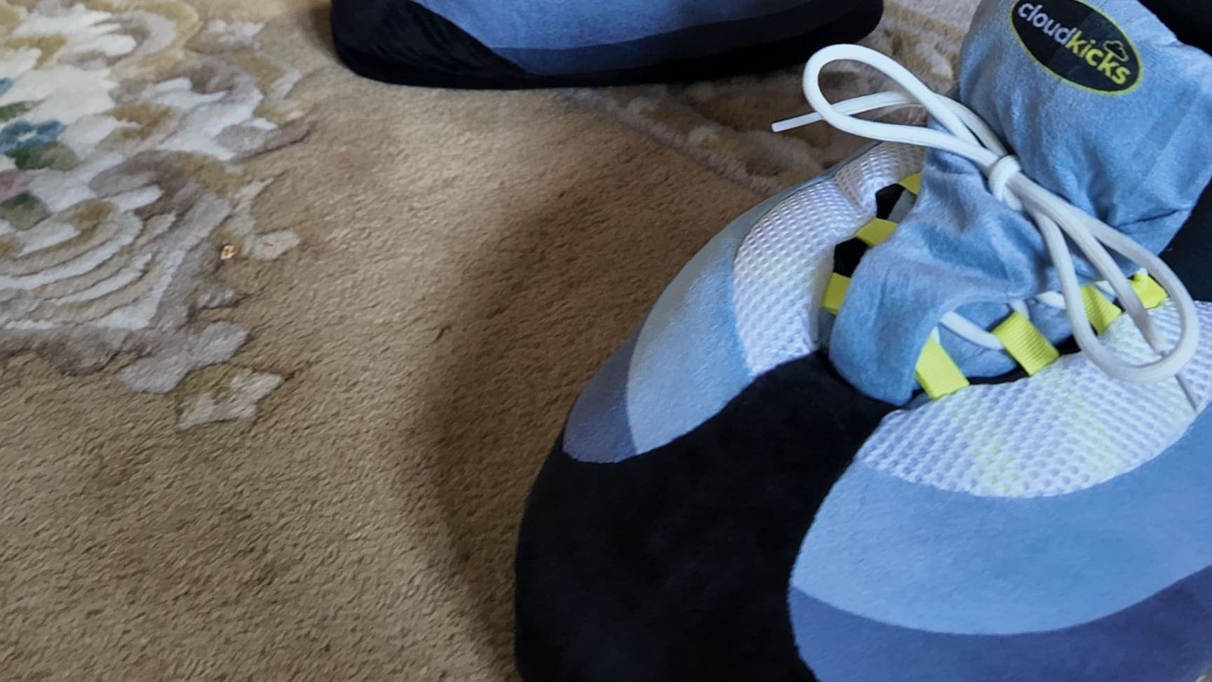 Close-up of OG Neon CloudKicks on a patterned rug