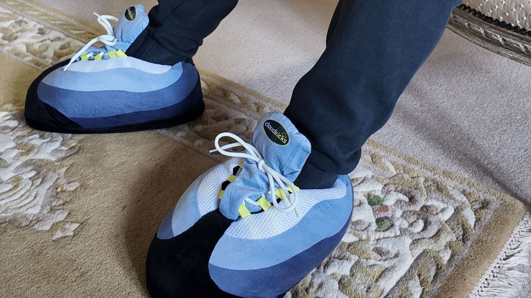 OG Neon CloudKicks on a patterned rug, navy joggers above