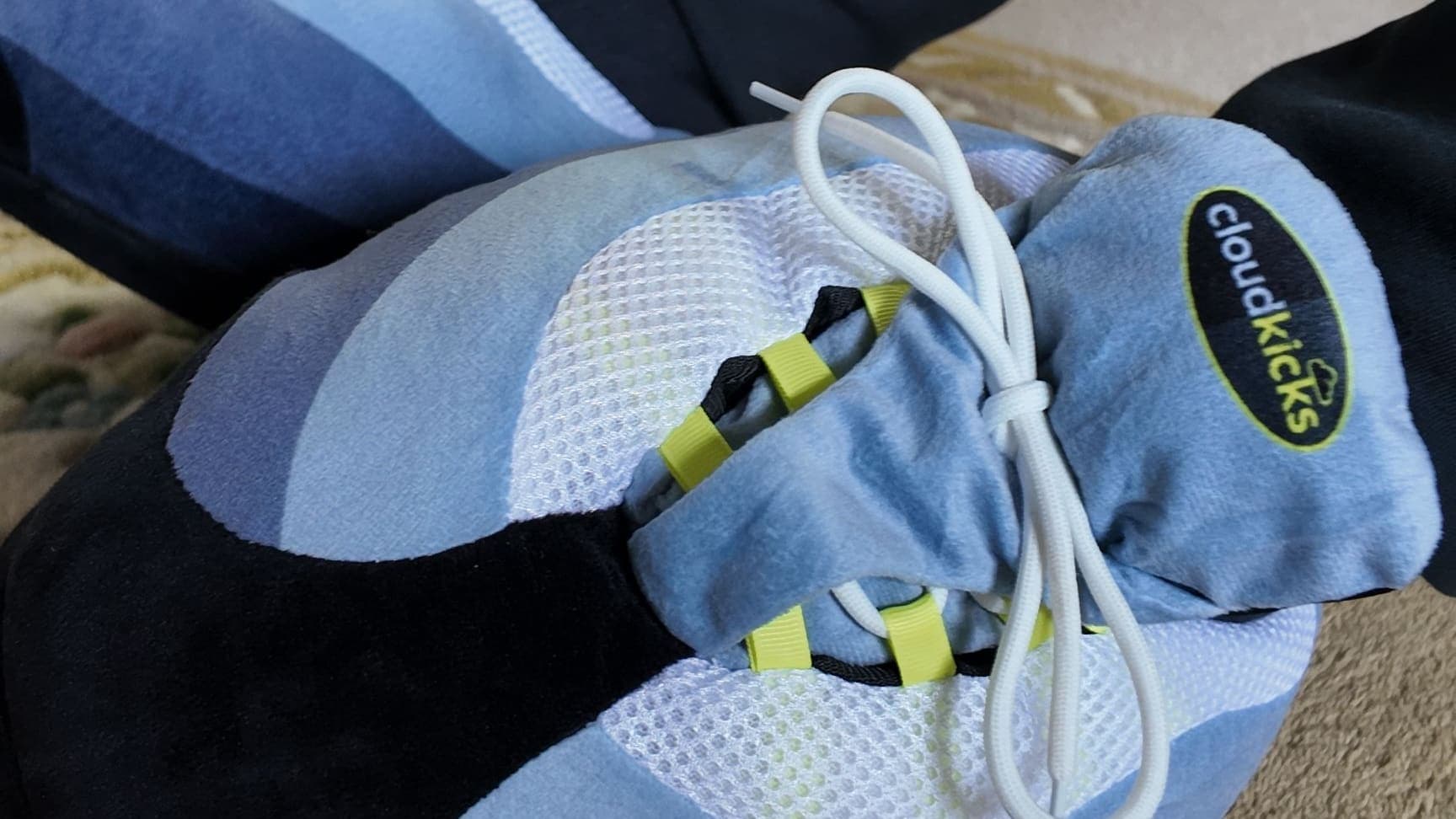 Close-up of crossed OG Neon CloudKicks showing the cloudkicks tongue badge and neon lace loops
