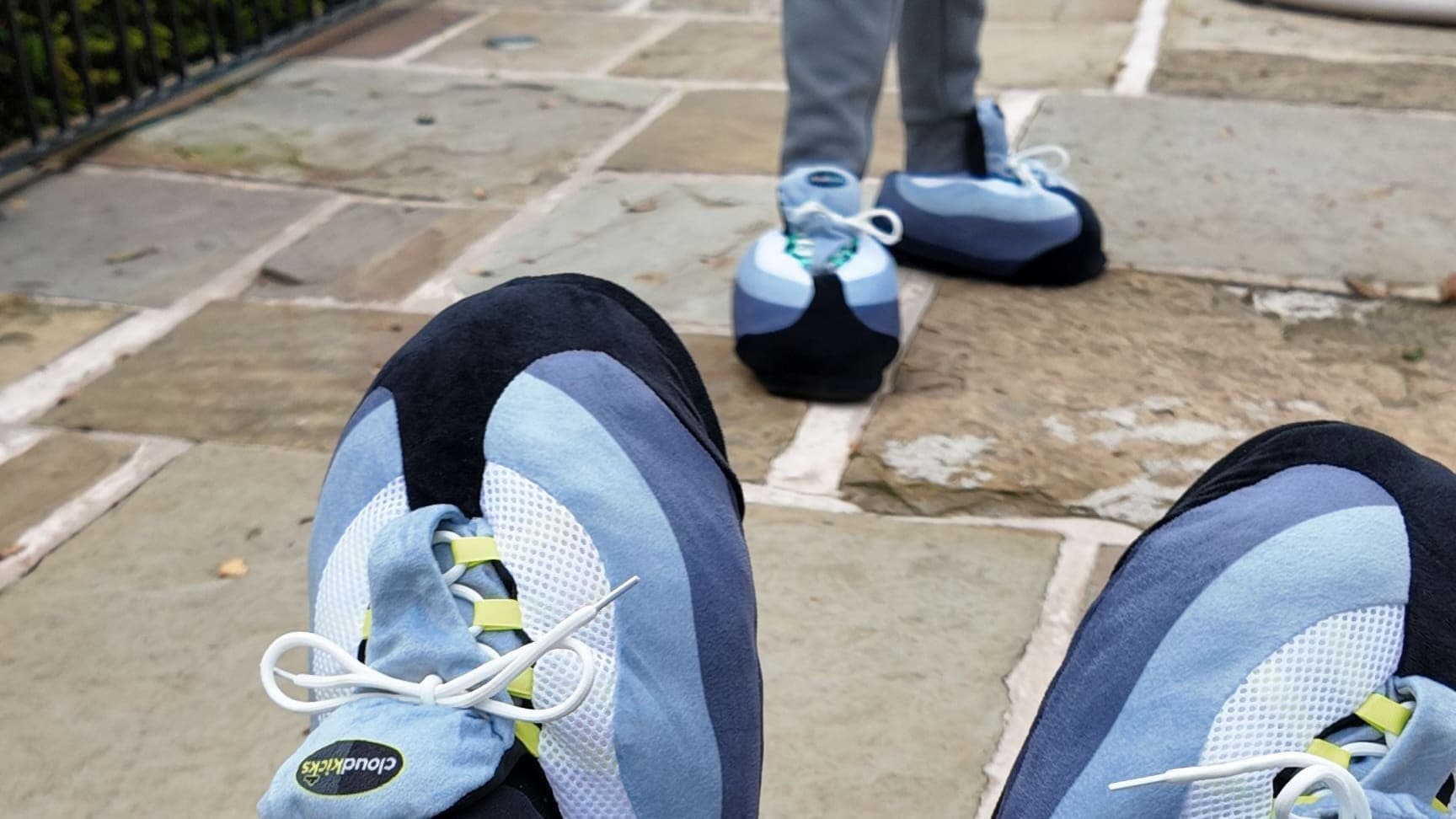 Point-of-view of OG Neon CloudKicks, with a friend in CloudKicks standing across the stone patio