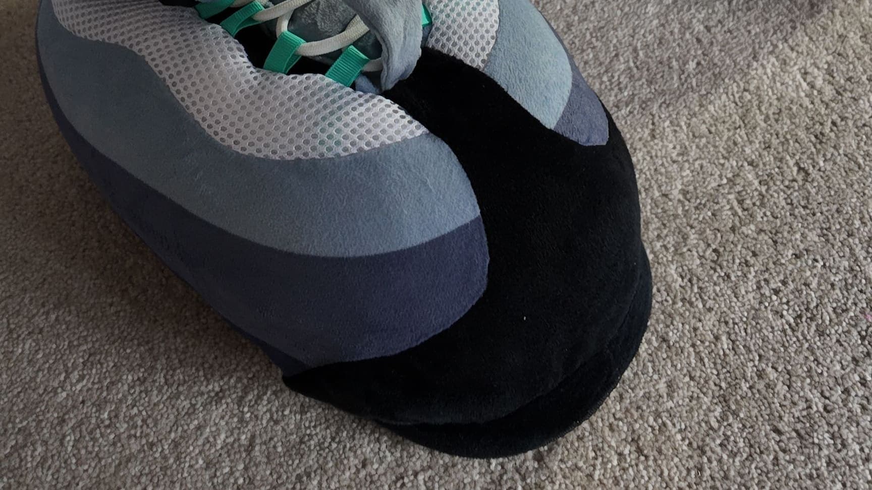 Close-up of a Hyper Turquoise CloudKick on a living-room carpet