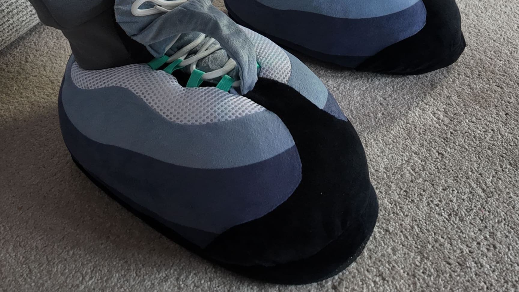 Close-up of Hyper Turquoise CloudKicks on a living-room carpet