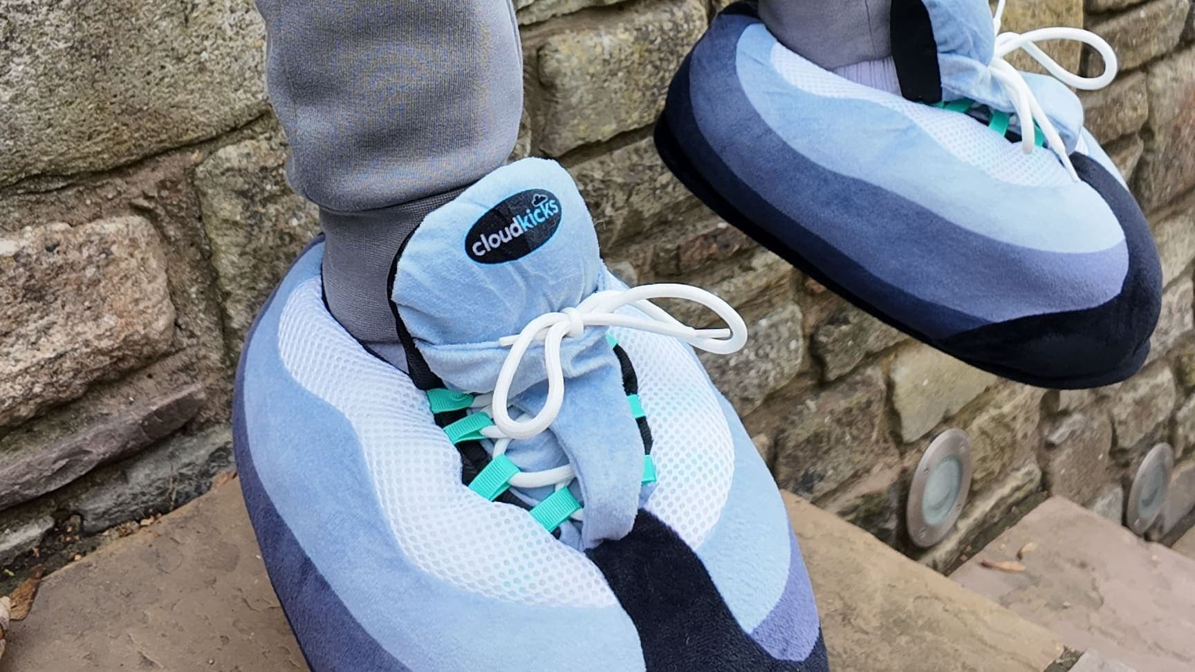 Hyper Turquoise CloudKicks on stone garden steps with grey joggers