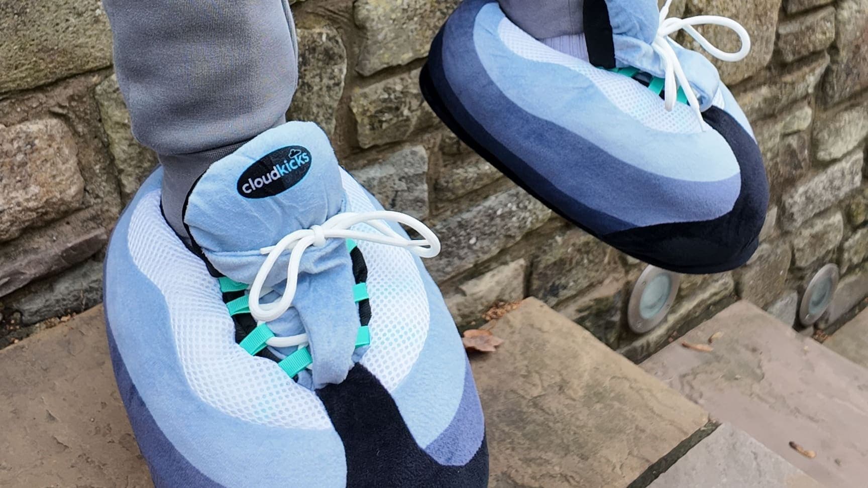 Hyper Turquoise CloudKicks on stone steps against an old stone wall